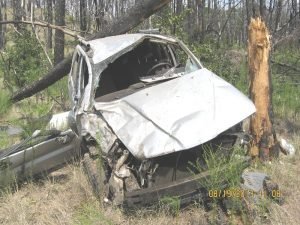 Wrecked car in woods